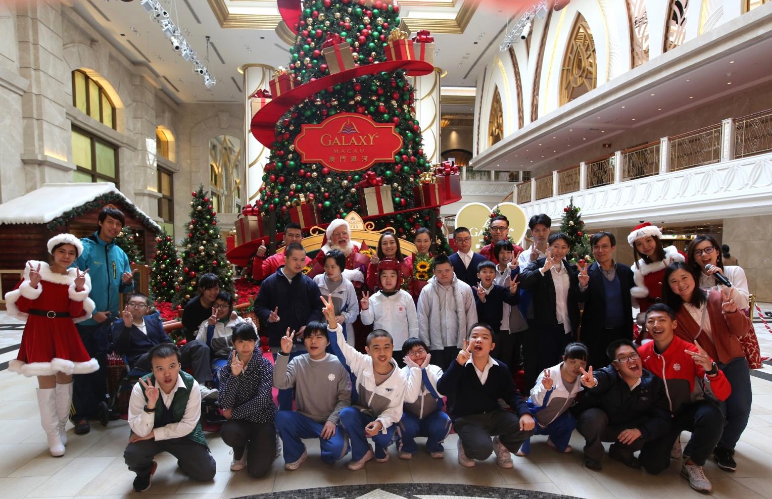 The gold medalists, Caritas students and Santa Ron took photos together.